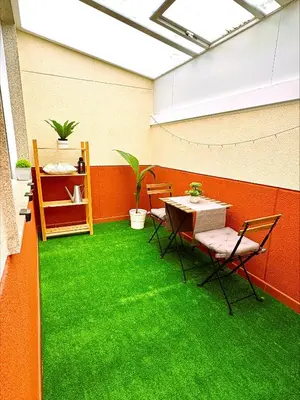 a room with a table and green grass at EnBURELA Sol y Playa in Burela de Cabo