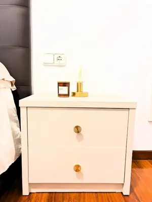 a white chest of drawers with a clock on it at EnBURELA Sol y Playa in Burela de Cabo