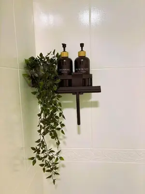 a shelf on a wall with three soap dispensers at EnBURELA Sol y Playa in Burela de Cabo