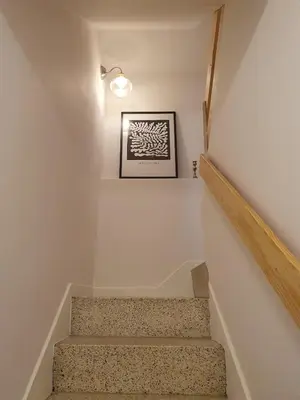 a staircase in a house with a picture on the wall at Casita en Fontán in Sada