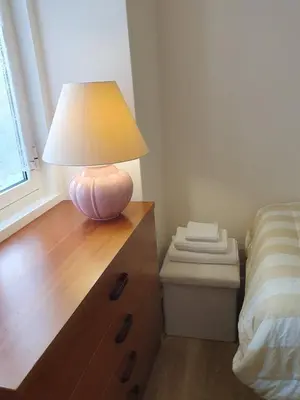 a lamp sitting on a dresser next to a bed at Casita en Fontán in Sada