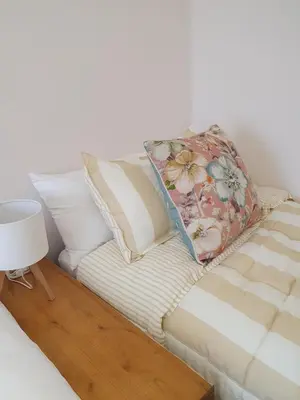 a couch with a pillow on top of it at Casita en Fontán in Sada