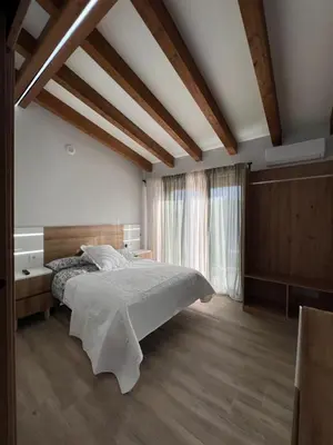 a bedroom with a bed and a large window at AMC Boente in Arzúa