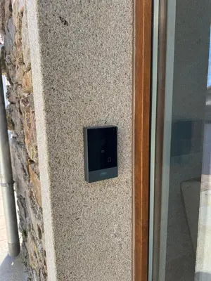 a small television on the side of a stone wall at AMC Boente in Arzúa