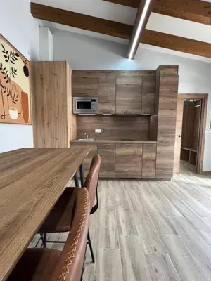 a dining room with a wooden table and chairs at AMC Boente in Arzúa