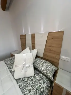 a bed with a white bow on top of it at AMC Boente in Arzúa