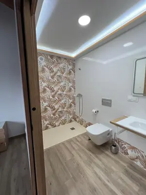 a bathroom with a toilet and a sink at AMC Boente in Arzúa