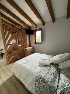 a bedroom with a large white bed with a window at AMC Boente in Arzúa