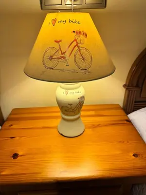 a lamp on a table with a picture of a bike on it at Apartamento Arnela Foz in Foz