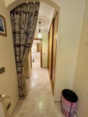 a hallway with a curtain and a trash can at Apartamento Arnela Foz in Foz