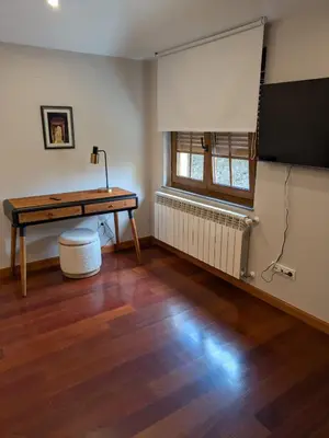 a room with a desk and a television in it at Casa Peruxo in Ribadeo
