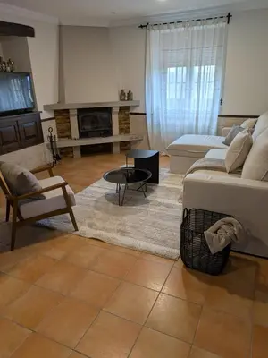 a living room with a couch and a fireplace at Casa Peruxo in Ribadeo