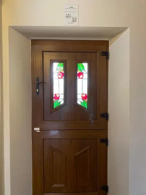 a wooden door with two windows in a room at Casa Peruxo in Ribadeo