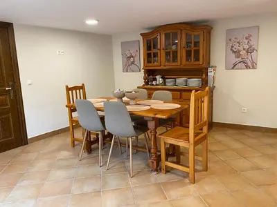 a dining room with a wooden table and chairs at Casa Peruxo in Ribadeo