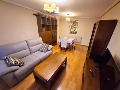 a living room with a couch and a table at Apartamento Playa Foz in Foz