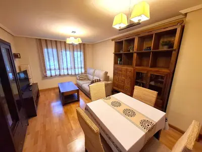 a living room with a table and a couch at Apartamento Playa Foz in Foz