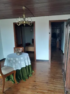a dining room with a table and a chandelier at casa en casco histórico in Allariz