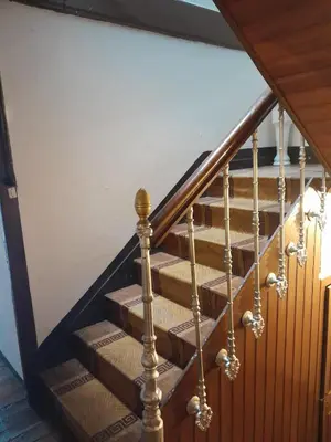 a set of stairs with a wooden railing at casa en casco histórico in Allariz