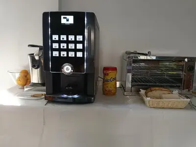 a black microwave sitting next to a toaster oven at alma de quireza in Santo Tomé