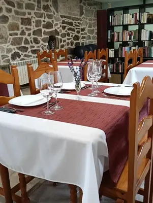 a table with wine glasses and plates on it at alma de quireza in Santo Tomé