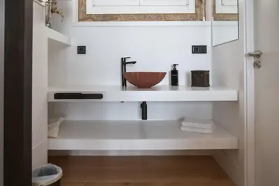 a bathroom sink with a bowl on a shelf at Granxa D Outeiro in Ribadavia