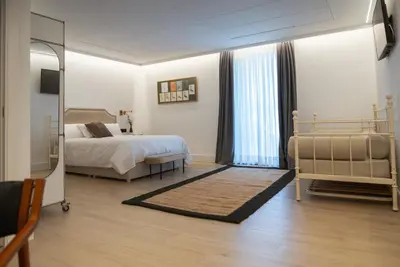 a bedroom with a bed and a mirror at Granxa D Outeiro in Ribadavia