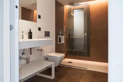 a bathroom with a toilet and a sink and a shower at Granxa D Outeiro in Ribadavia
