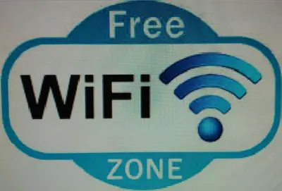 a sign that says free wifi zone at Hotel Puente de los Santos in Tapia de Casariego