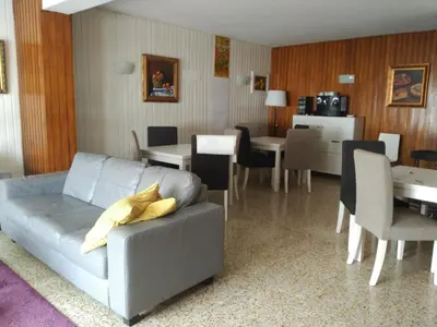 a living room with a couch and a dining room at Hotel Puente de los Santos in Tapia de Casariego