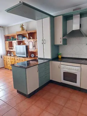 a kitchen with green and white cabinets and appliances at Alojamiento Sena VUT LE-1254 in Villablino