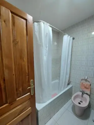 a bathroom with a shower and a toilet and a sink at Alojamiento Sena VUT LE-1254 in Villablino