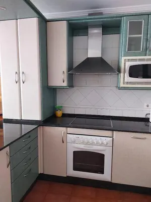 a kitchen with white cabinets and a stove top oven at Alojamiento Sena VUT LE-1254 in Villablino