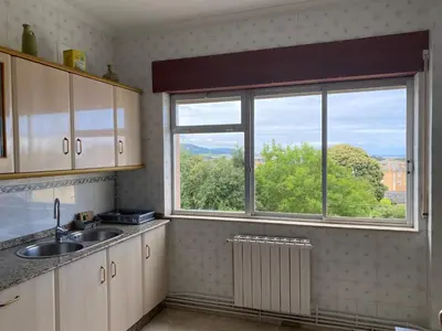 a kitchen with a sink and a window at Piso Brisa de Barreiros in San Cosme de Barreiros