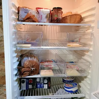 a refrigerator filled with food and other food items at casa rural San Vicente Borrenes in Borrenes