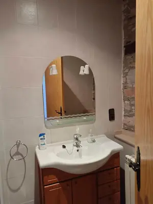 a bathroom with a sink and a mirror at casa rural San Vicente Borrenes in Borrenes