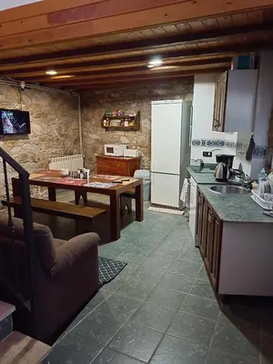 a kitchen with a table and a sink and a counter top at casa rural San Vicente Borrenes in Borrenes
