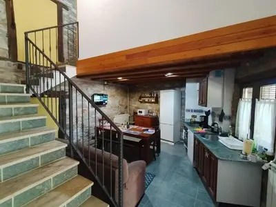 a kitchen with a staircase leading to a kitchen with a counter at casa rural San Vicente Borrenes in Borrenes