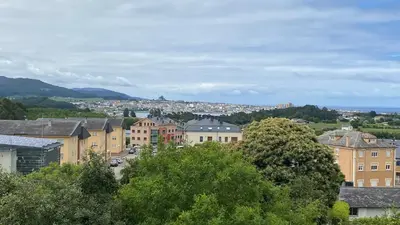 a view of a city with buildings and trees at Piso Mirador de San Cosme in San Cosme de Barreiros