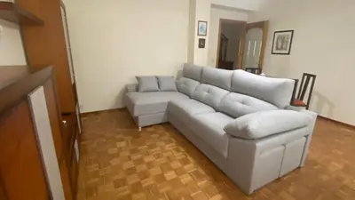 a living room with a white couch and a table at Piso Mirador de San Cosme in San Cosme de Barreiros