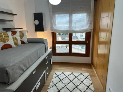 a bedroom with a bed with a dresser and a window at #Las Azaleas# in Teijois