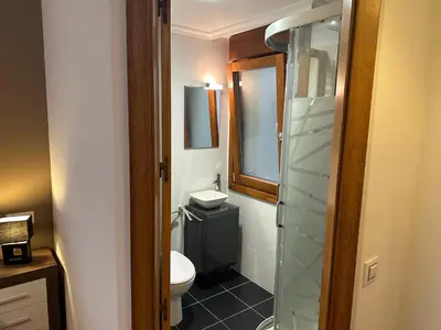 a bathroom with a toilet and a glass shower at #Las Azaleas# in Teijois