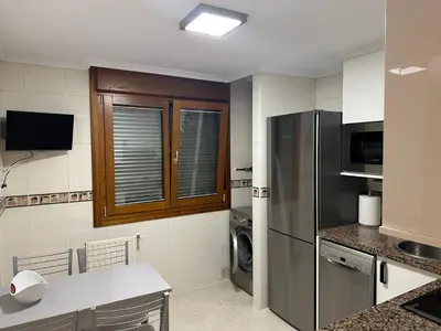 a kitchen with a refrigerator and a washer and dryer at #Las Azaleas# in Teijois