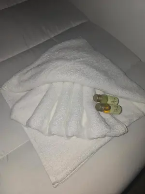 a white towel sitting on top of a bed at Eneas I , II in A Pontenova