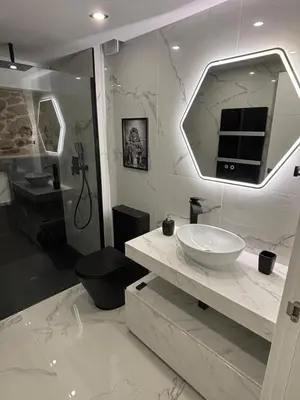a bathroom with a sink and a large mirror at Casa vacacional San Miguel in Maside