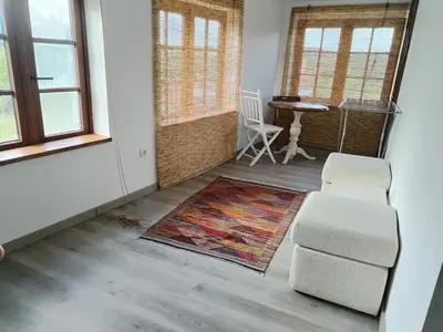 a living room with two chairs and a rug at Casa Quinzan Ribeira Sacra in Taboada