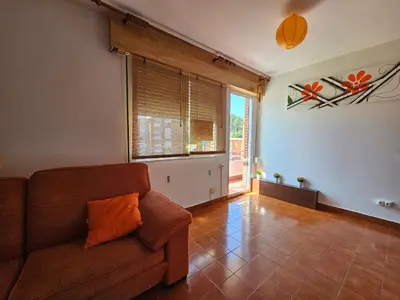 a living room with a couch and a large window at Apartamento Playa de Ber in Puentedeume