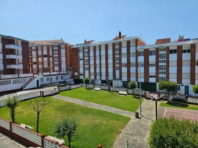 a park in the middle of a city with buildings at Apartamento Playa de Ber in Puentedeume