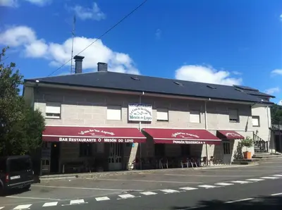 a building on the side of a street at Hostal Meson do Loyo in Portomarin