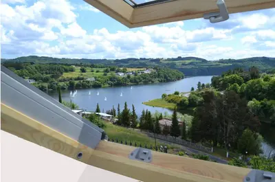 a view of a river from the balcony of a house at Hotel Ferramenteiro de Portomarin in Portomarin