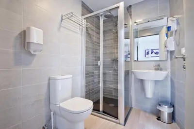 a bathroom with a toilet and a sink at Hotel Ferramenteiro de Portomarin in Portomarin